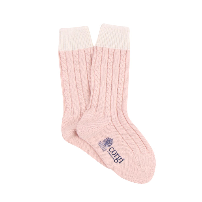Pink sock with cable knit pattern and visible brand logo on a white background

