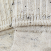 Close-up of textured beige fabric with a ribbed pattern