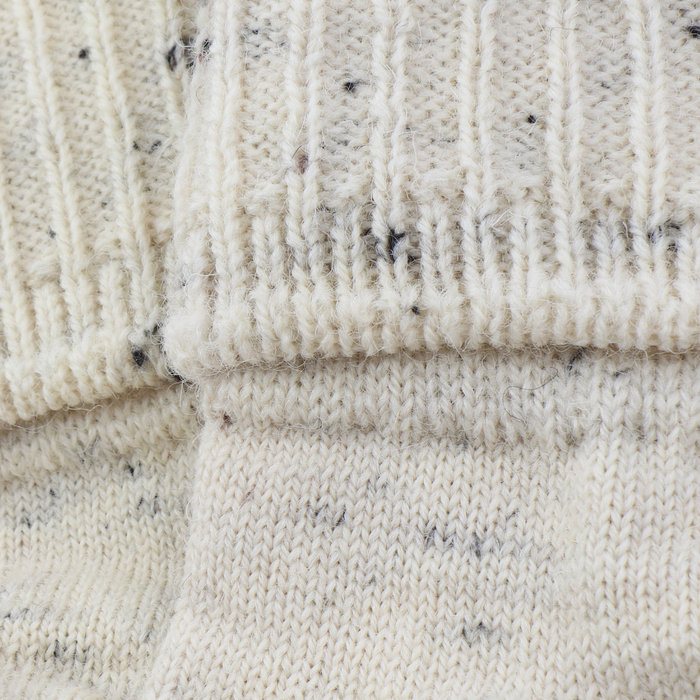 Close-up of textured beige fabric with a ribbed pattern