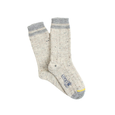 A pair of beige and gray striped cuff British wool socks with a yellow detail at the toe.