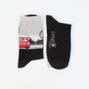 A pair of women's socks with a London theme, featuring a red double decker bus on a black and silver background.
