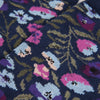 Close-up of a floral patterned fabric with pink, purple, and blue flowers on a dark background.