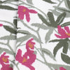 Close-up of fabric with pink floral and green leaf pattern on a white background