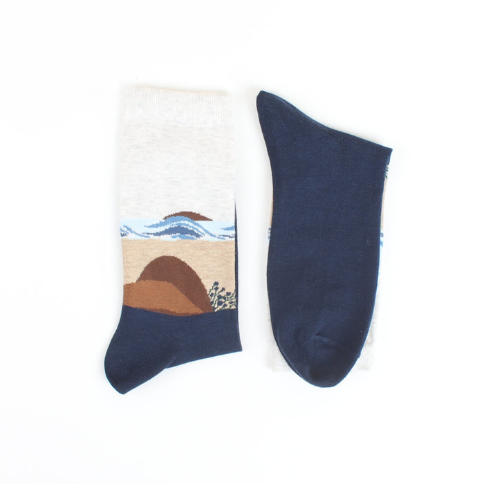 Navy blue sock with beach landscape design on a white background