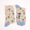 Beige socks with tropical pattern and blue heel and toe photographed  on a white background