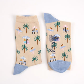 Beige socks with tropical pattern and blue heel and toe photographed  on a white background