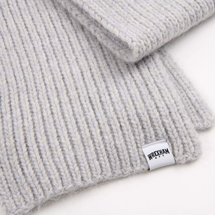 Grey knit beanie with a brand label on a white background