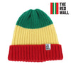 A striped wool beanie hat in green, yellow, and red colors, with 'THE RED WALL' text on the side.
