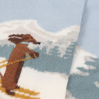 Knitted sock with a dachshund design on a blue background