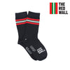 A pair of kids' socks with a striped pattern in red, white, and blue colors, featuring the text 'THE RED WALL' on the foot area.