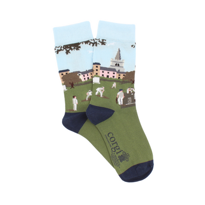 A pair of patterned cotton socks featuring a cricket scene with players on a green field, designed for children.