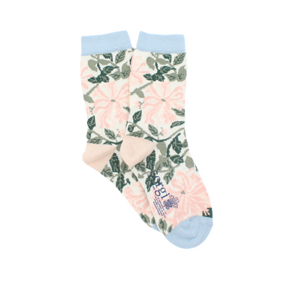 A pair of kids' socks with a William Morris Honeysuckle floral pattern in cream and pink colors, with a pale blue cuff, heel, and toe.
