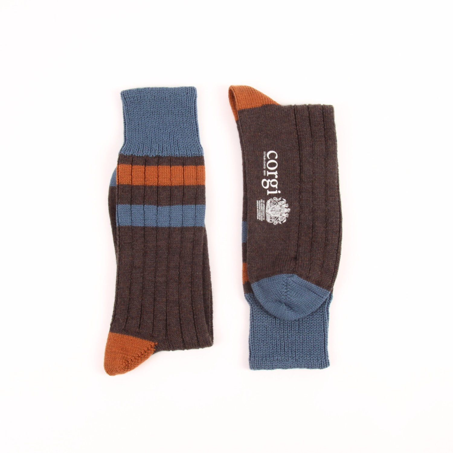 A pair of ribbed crew socks shown flat on a white background, one sock standing upright and the other laid on its side. The socks are primarily dark brown with a slate blue cuff, heel, and toe, accented by orange stripes and matching orange toe and heel sections.