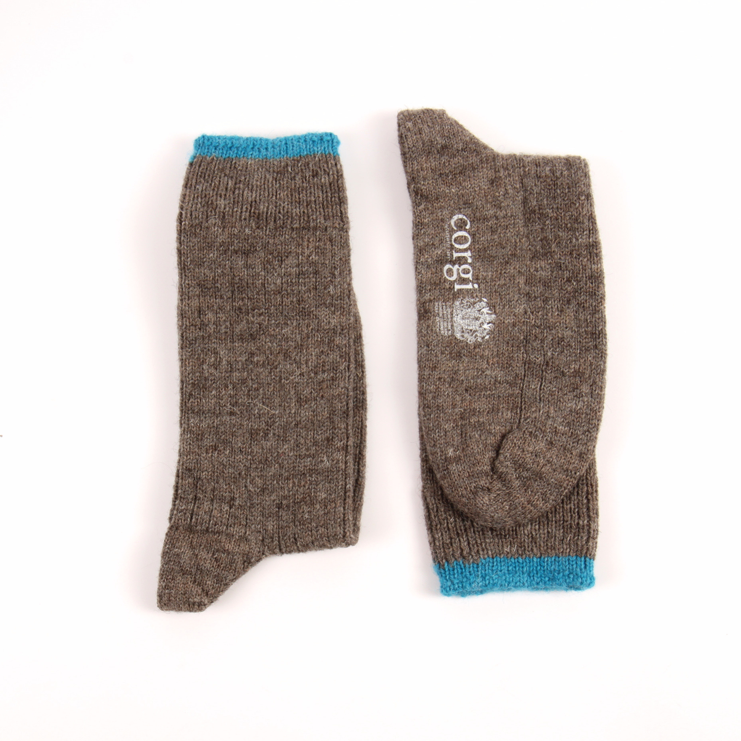 A pair of brown knit socks shown flat on a white background, with one sock standing upright to show the blue ribbed cuff and the other laid down to show the toe and the white 'Corgi' brand logo.