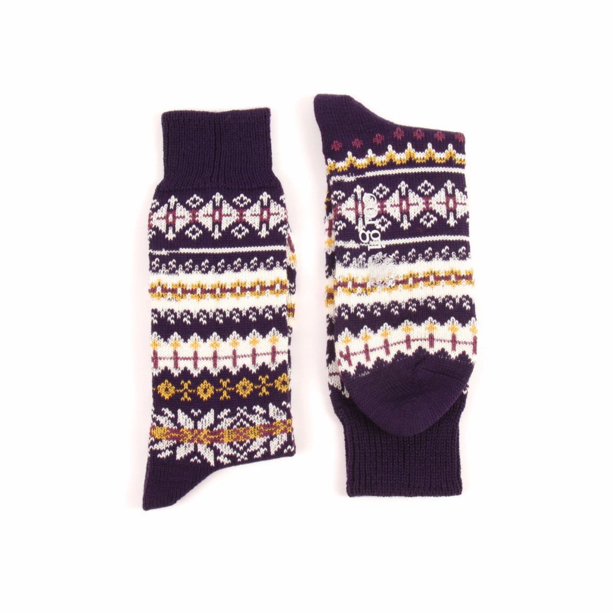 A pair of dark purple knit socks with traditional Fair Isle patterns in white, yellow, and burgundy, displayed flat against a white background.