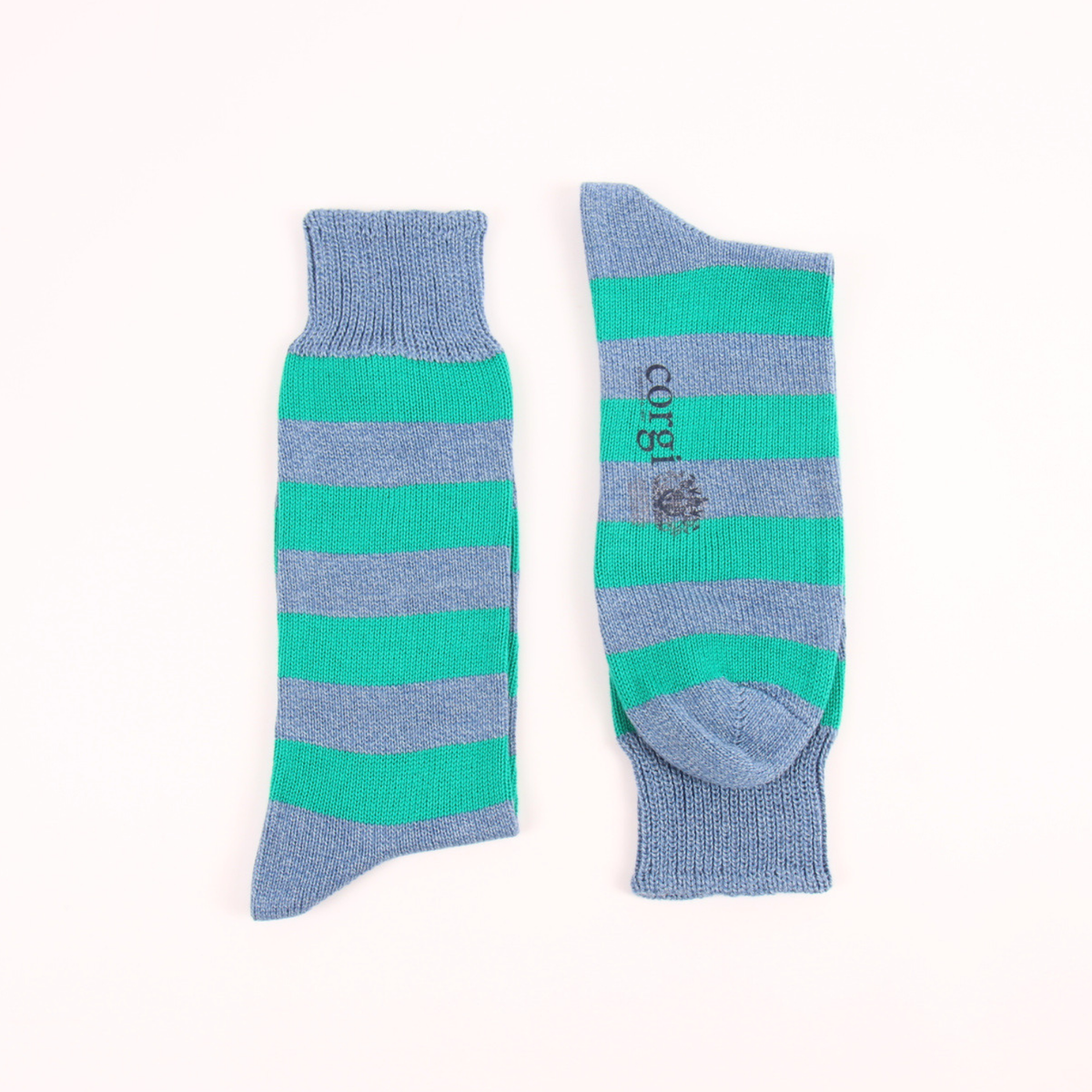 Two striped knit socks laid flat on a white background, one showing the side with teal and dusty blue horizontal stripes, and the other showing the top with the brand name 'cotbii' printed vertically.