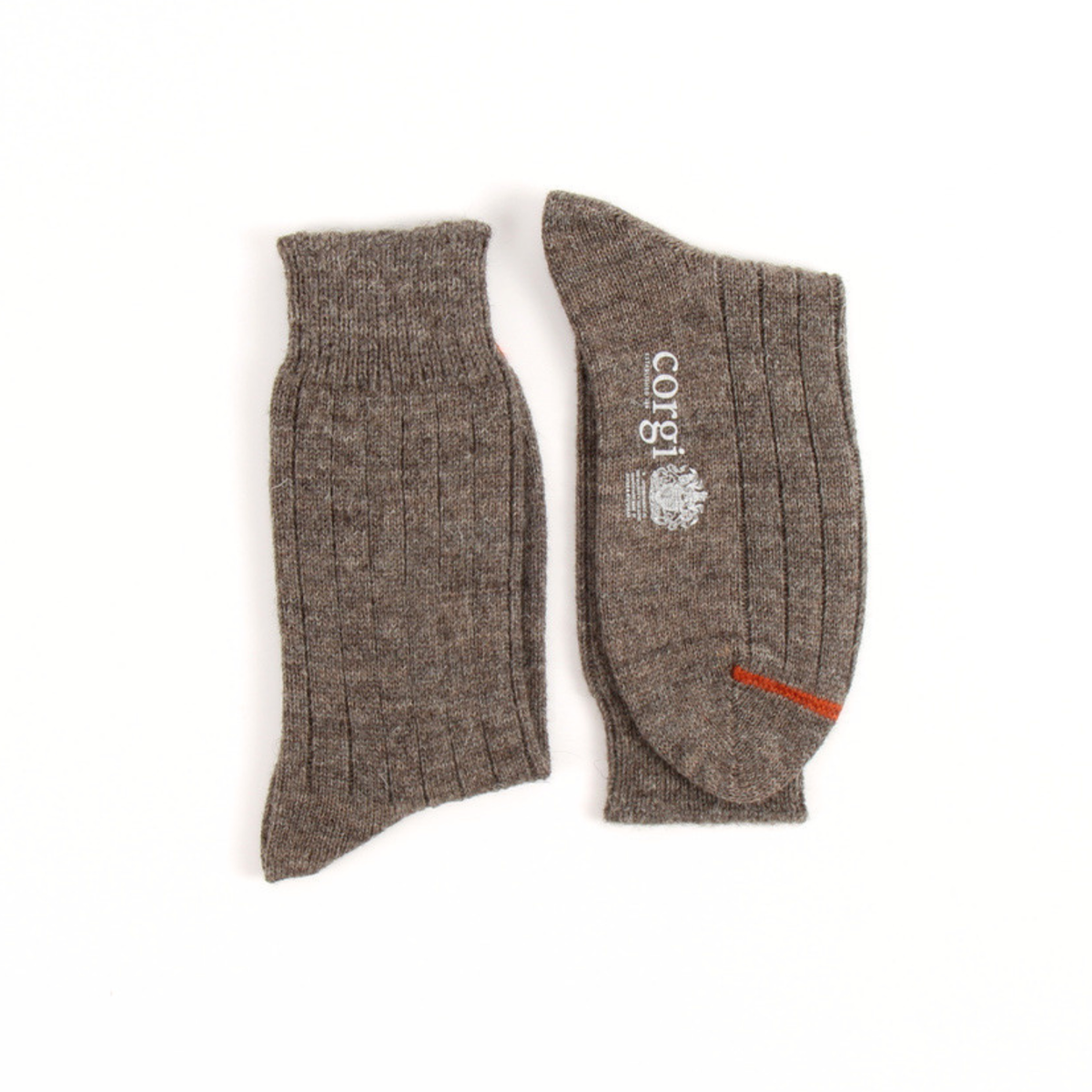 A pair of ribbed knit ankle socks in a heathered taupe-brown color, displayed flat against a white background. One sock shows the side with a white vertical 'corgi' logo, and the other shows the sole with a small orange accent stripe.