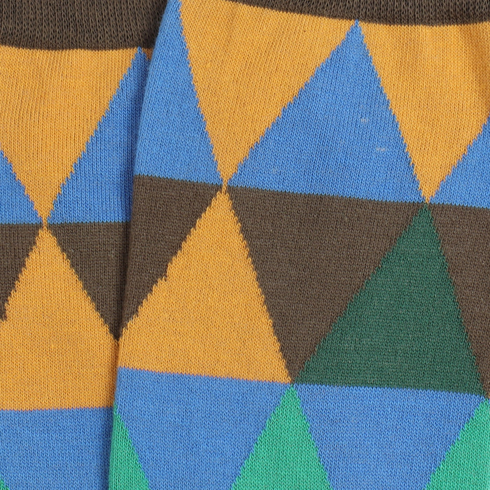 Close-up of patterned fabric with blue, yellow, and green triangles.