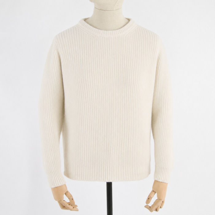 Beige sweater on a mannequin against a white background