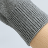 Close-up of a gray knitted sleeve on a light gray background