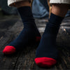Navy socks with red toes on a wooden floor