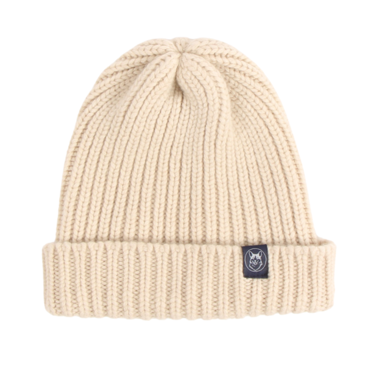 A cream-colored ribbed knit beanie hat with a small black brand patch on the cuff, shown against a plain white background.
