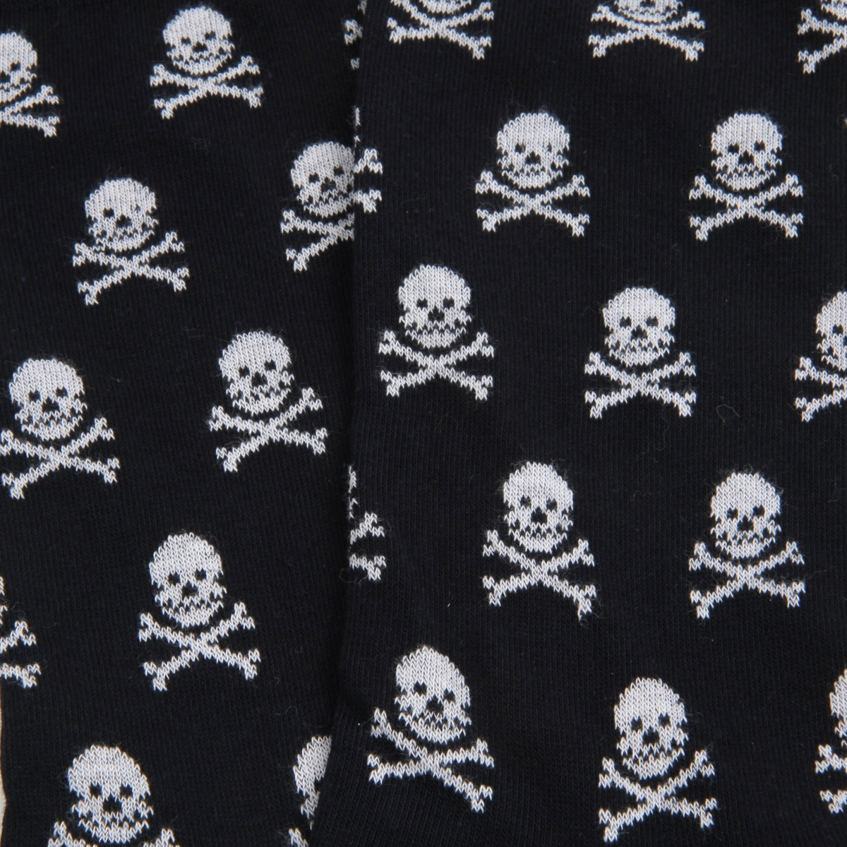 navy knit fabric with an allover white skull and crossbones pattern, shown in a close-up view.