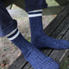 Blue marl pure cotton knitted socks with white stripes on a wooden bench