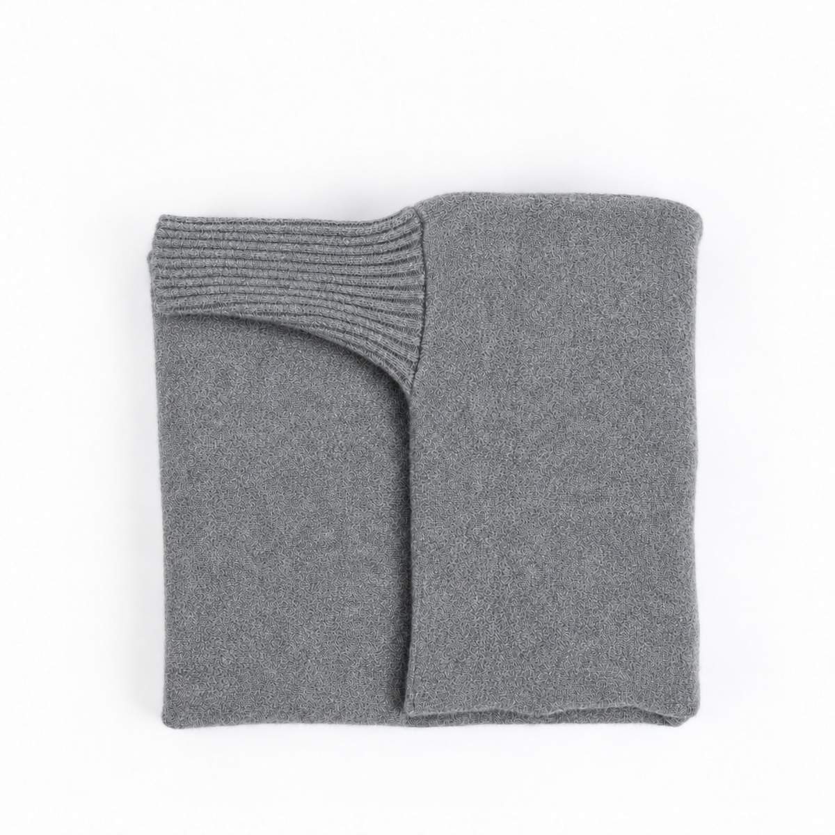 A folded gray knit sweater or sweater with a ribbed cuff, photographed on a clean white background.