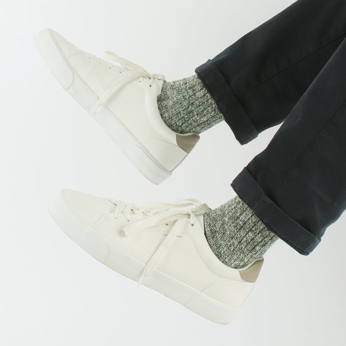 man wearing green marl wool socks