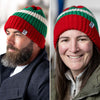 Two adults, one male and one female, wearing a red, green, and white striped wool beanie hat.