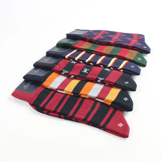 Stack of colorful striped socks on a white background