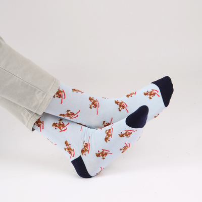 Pale blue socks with skiing squirrel pattern on a white background