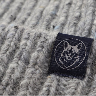 Textile label with a Corgi dog design on a textured fabric background