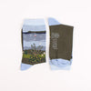 Pair of socks with a scenic design and brand logo on a white background