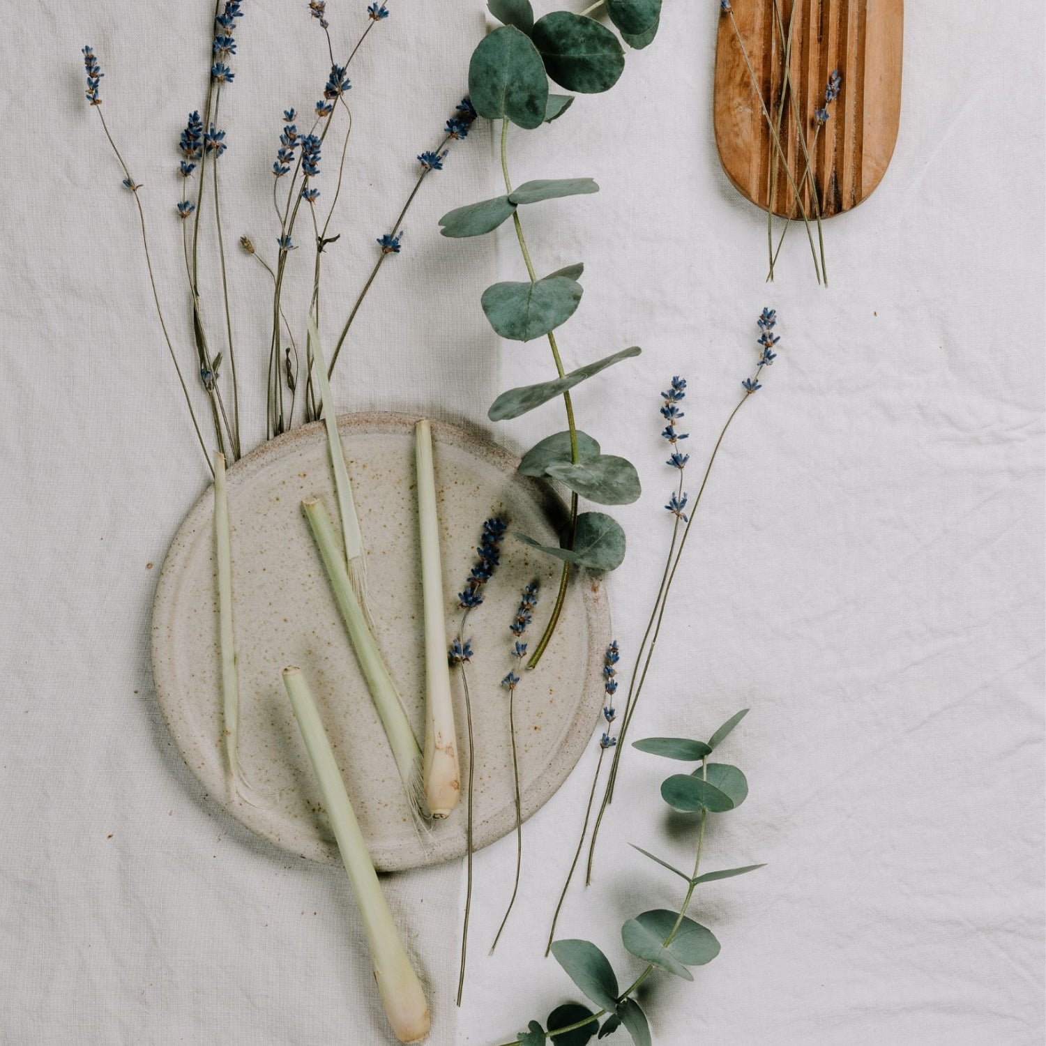Herbs and flowers on a linen tablecloth. 
