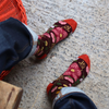 Person wearing floral patterned socks on a concrete floor