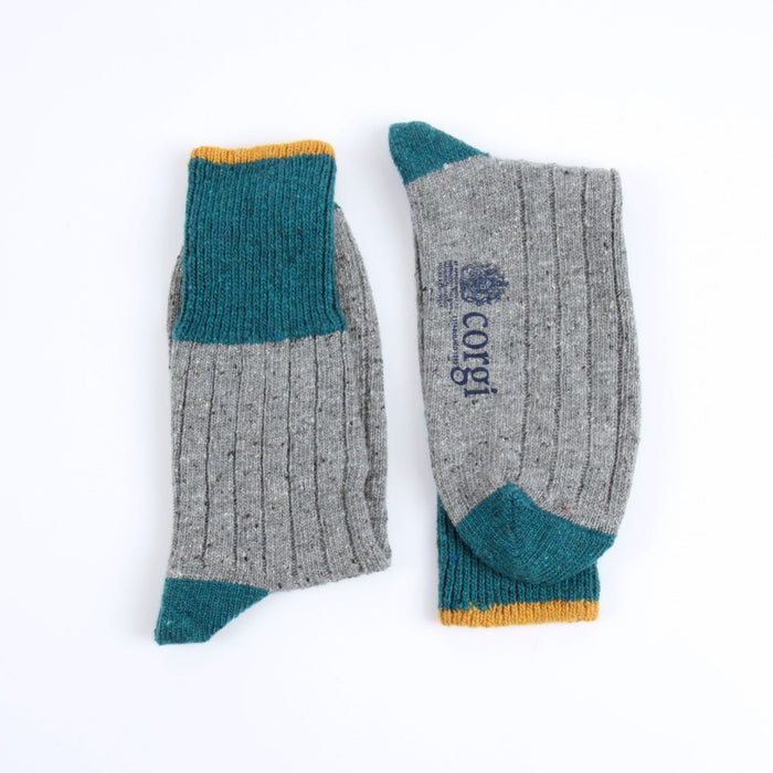 Pair of gray and teal socks with 'corgi' branding on a white background