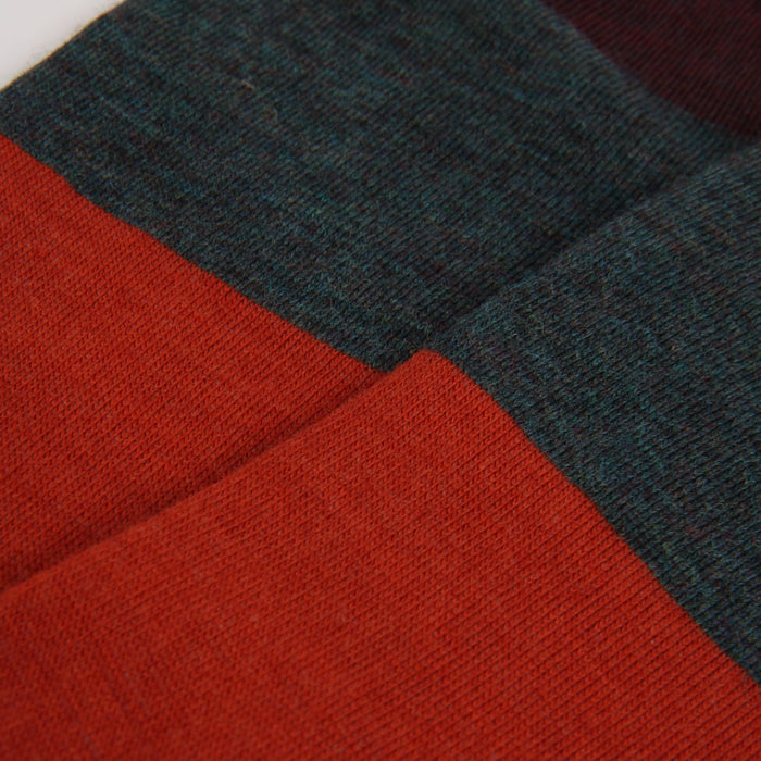 Close-up of orange and dark green fabric with a textured pattern