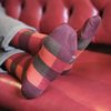 Checked socks on a red couch
