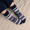 Person wearing patterned socks on a textured surface