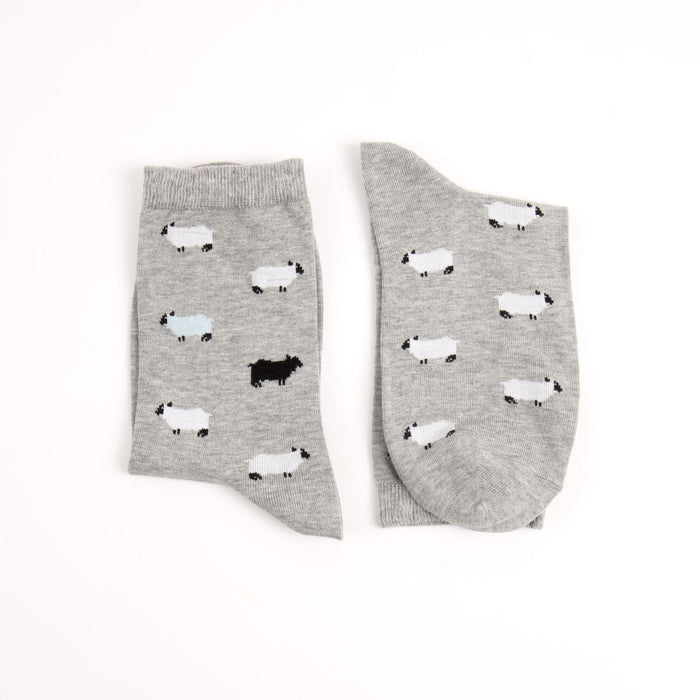 Gray socks with sheep pattern on a white background