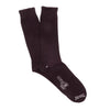Pair of dark brown socks on a white background