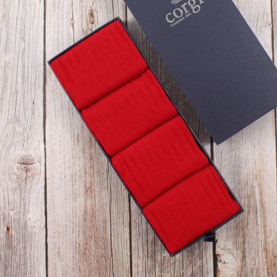 A set of red merino wool socks presented in a Corgi branded box, designed for daily wear and suitable for various sizes.