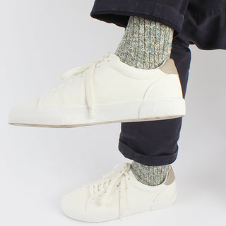 man wearing green marl pure cotton socks with white trainers