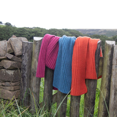pure cashmere scarves on a wooden gate in the Welsh hills