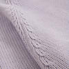 Close-up of a textured purple fabric with knit pattern
