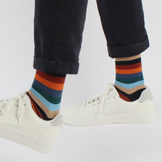 man wearing striped colourful cotton socks with white trainers