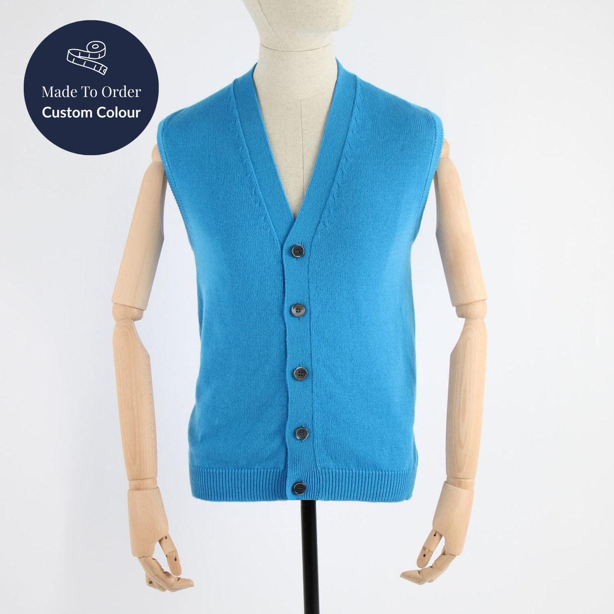 Blue cardigan vest on a mannequin with 'Made to Order Custom Colour' label.