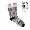 Pair of socks with leaf pattern and William Morris Gallery branding.